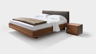 Riletto Bett mit Bettseiten in Holz und in Nussbaum. Riletto Bett mit Kopfteil in Leder scharz.